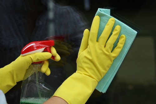 Carpet cleaning technician preparing equipment in a safe working environment